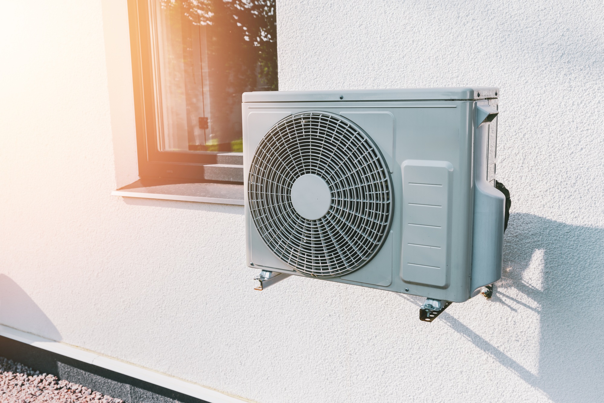 Multiple technicians installing air conditioners across a building